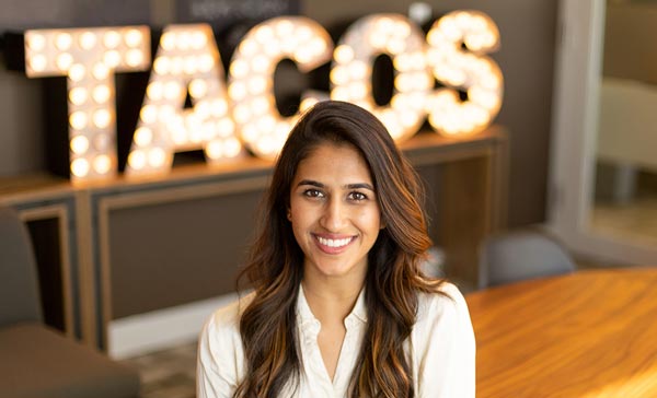 Richa in front of taco sign smiling